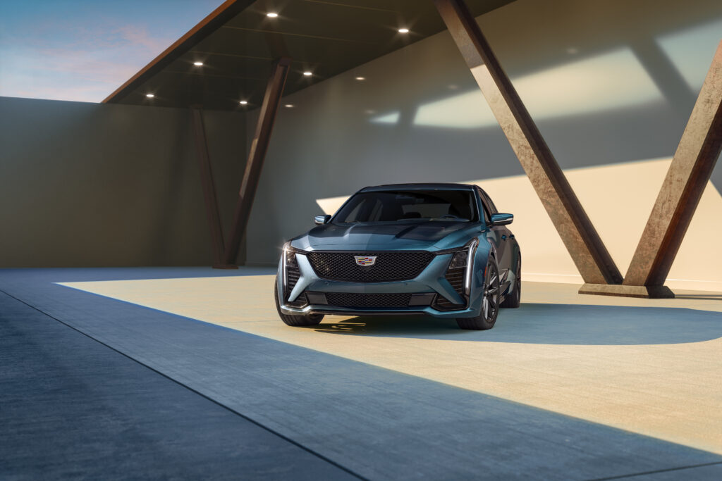 Blue Cadillac CT5 parked in a modern architectural space, featured in our Cadillac CT5 Review.