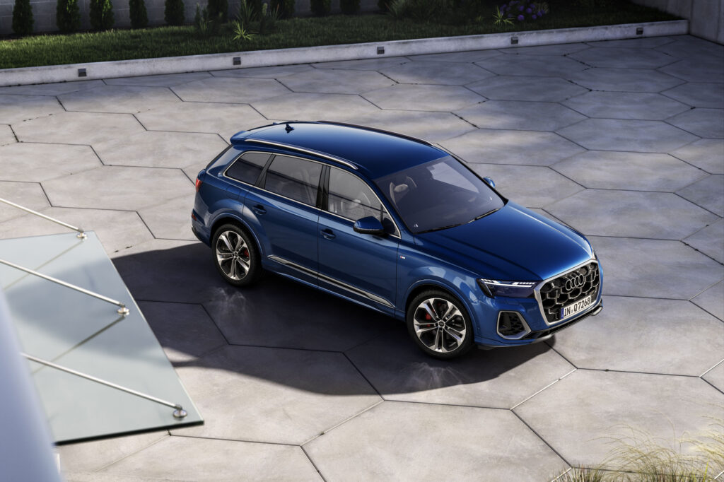 Blue Audi Q7 luxury SUV shown from an elevated angle in a modern courtyard for an Audi Q7 Review.