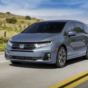 Honda Odyssey Review image of a blue 2026 Honda Odyssey driving, front three-quarter view