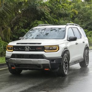 Honda Passport Review image of a white 2026 Honda Passport TrailSport on a wet road