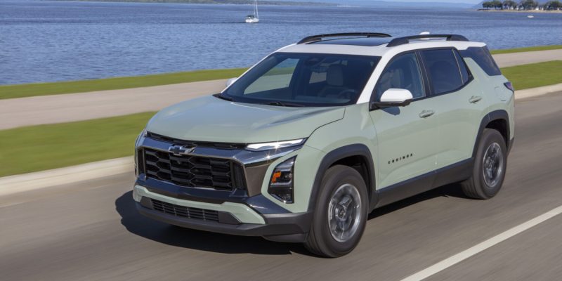 2026 Chevrolet Equinox driving beside a lake, featured in Chevrolet Equinox Review