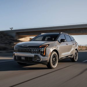 Kia Sportage Review image of a gray 2026 Kia Sportage driving on a highway