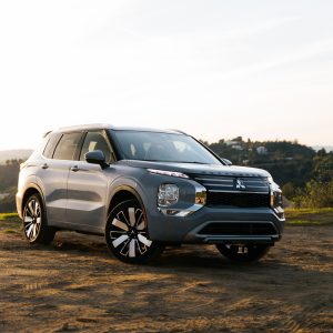 Silver Mitsubishi Outlander SUV parked on a dirt overlook at sunset for a Mitsubishi Outlander Review.