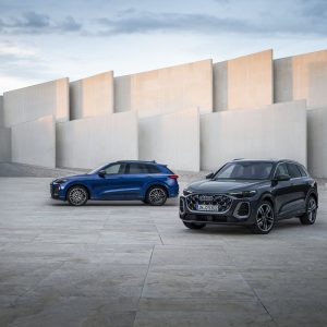 Two 2026 Audi Q5 SUVs parked in a modern concrete courtyard for an Audi Q5 Review.