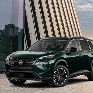2026 Nissan Rogue compact SUV parked outdoors, showcasing modern design and bold front grille.