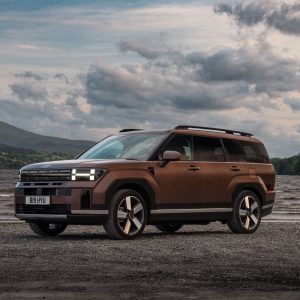 2026 Hyundai Santa Fe parked by a lake with mountains in the background